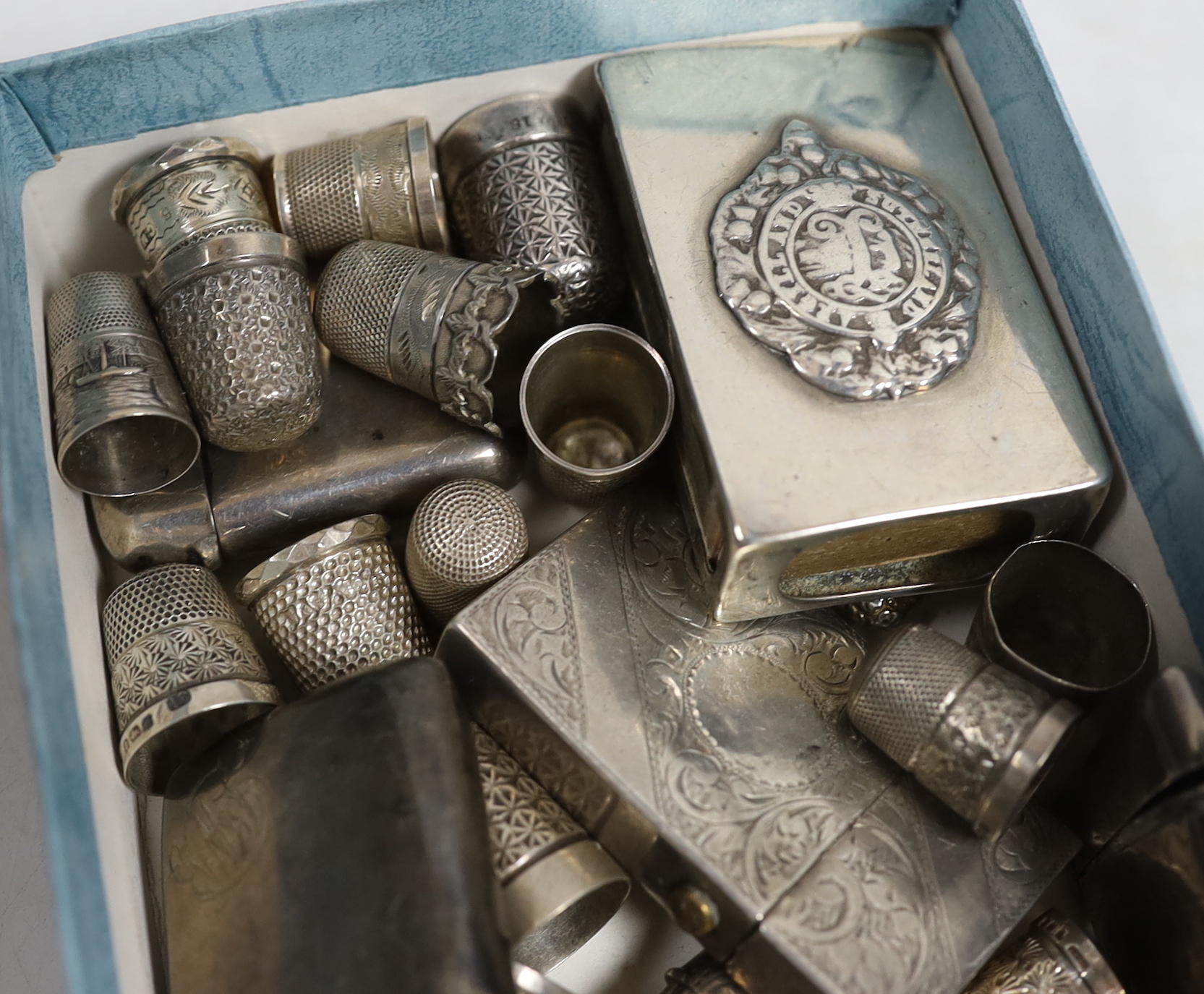 Five assorted early 20th century silver vesta cases, a similar French white metal vesta case, a silver matchbox sleeve, a sterling lighter, together with fifteen silver thimbles including Charles Horner, two sterling thi